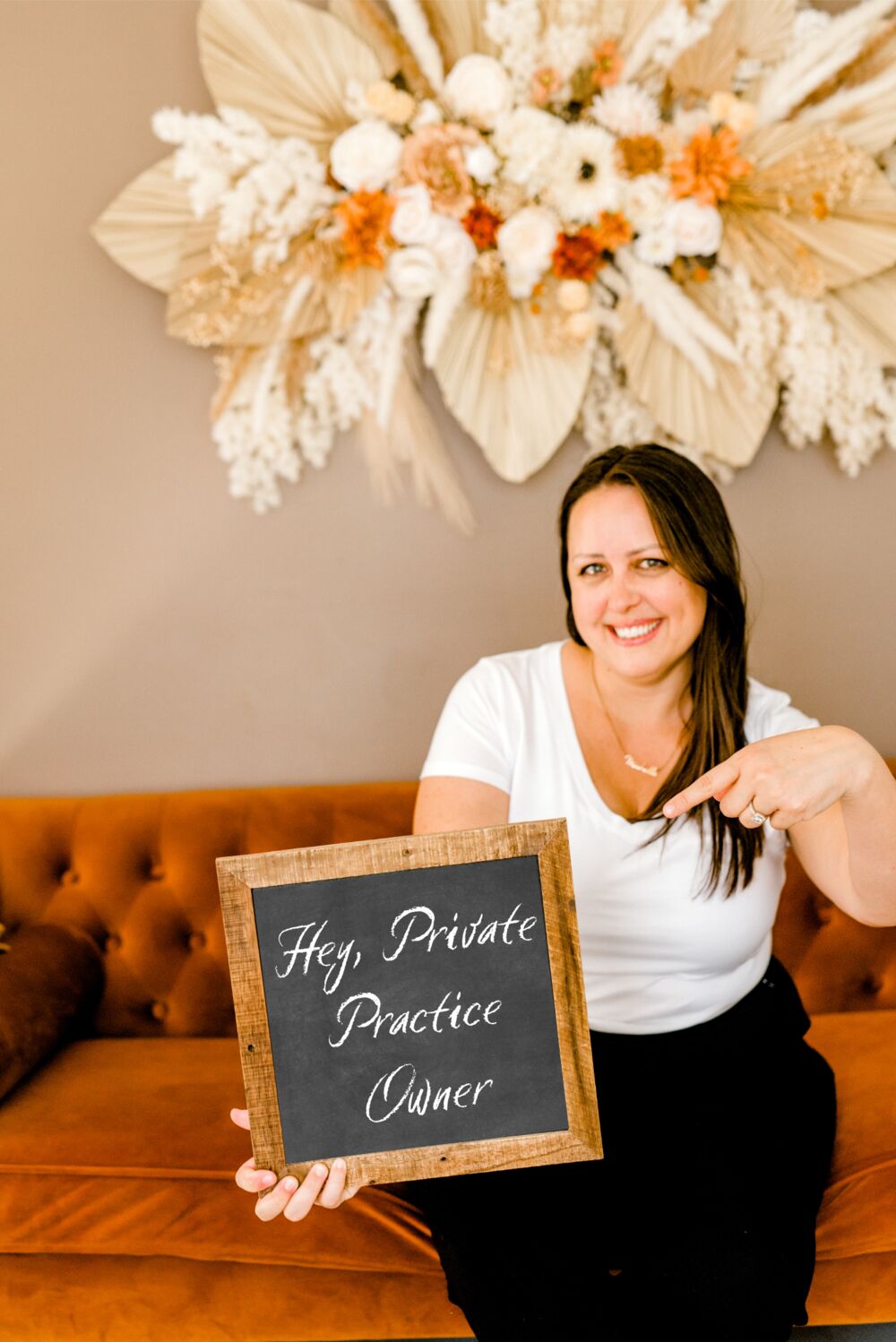 Michelle Polk holding a chalkboard sign that reads “Hey, Private Practice Owner”